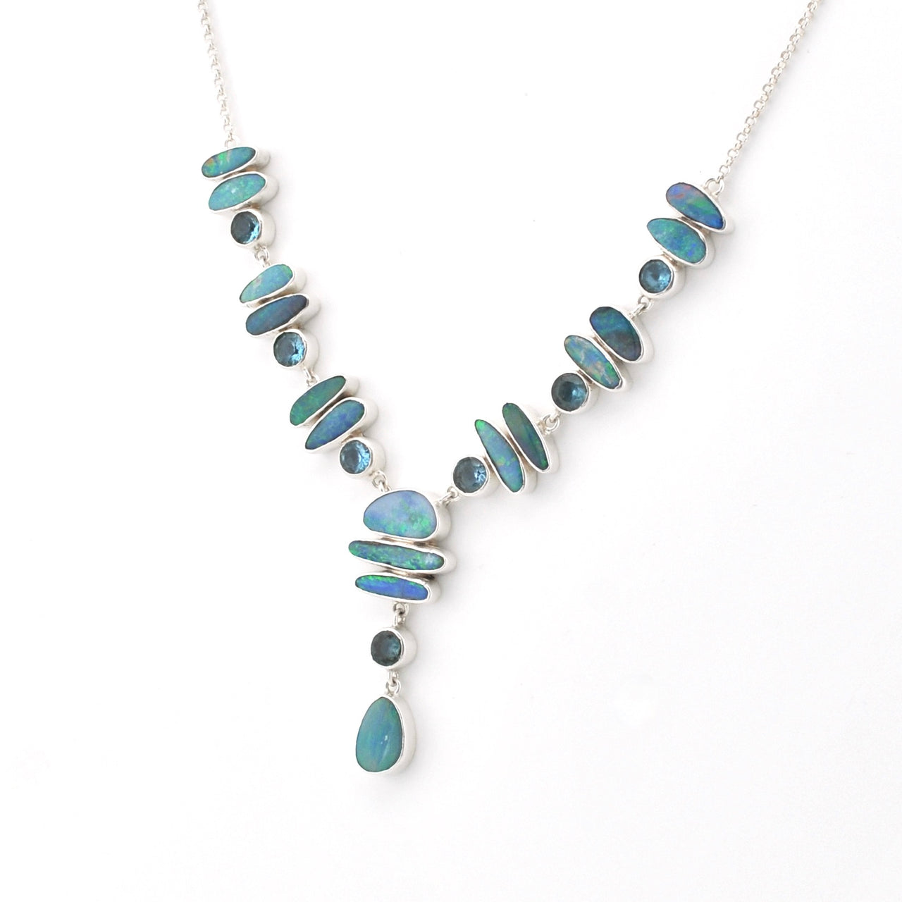A silver Y-shaped necklace featuring inlaid blue-green opal stones of various shapes and sizes, with a teardrop-shaped opal drop pendant, shown on a plain white background.