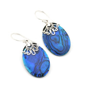 A pair of teardrop-shaped drop earrings featuring vibrant blue abalone shell inlays with natural marbled patterns, suspended from silver-tone French wire filigree hoops and fishhook ear wires, set against a plain white background.