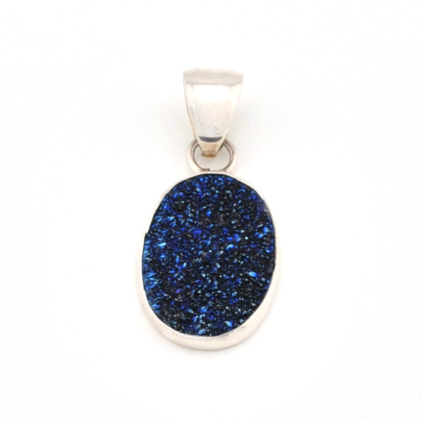 Blue stone pendant with silver frame on a white background