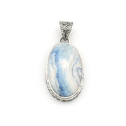 An oval pendant featuring a blue and white marbled stone, set in a textured silver bezel with an ornate silver bail, shown on a plain white background.