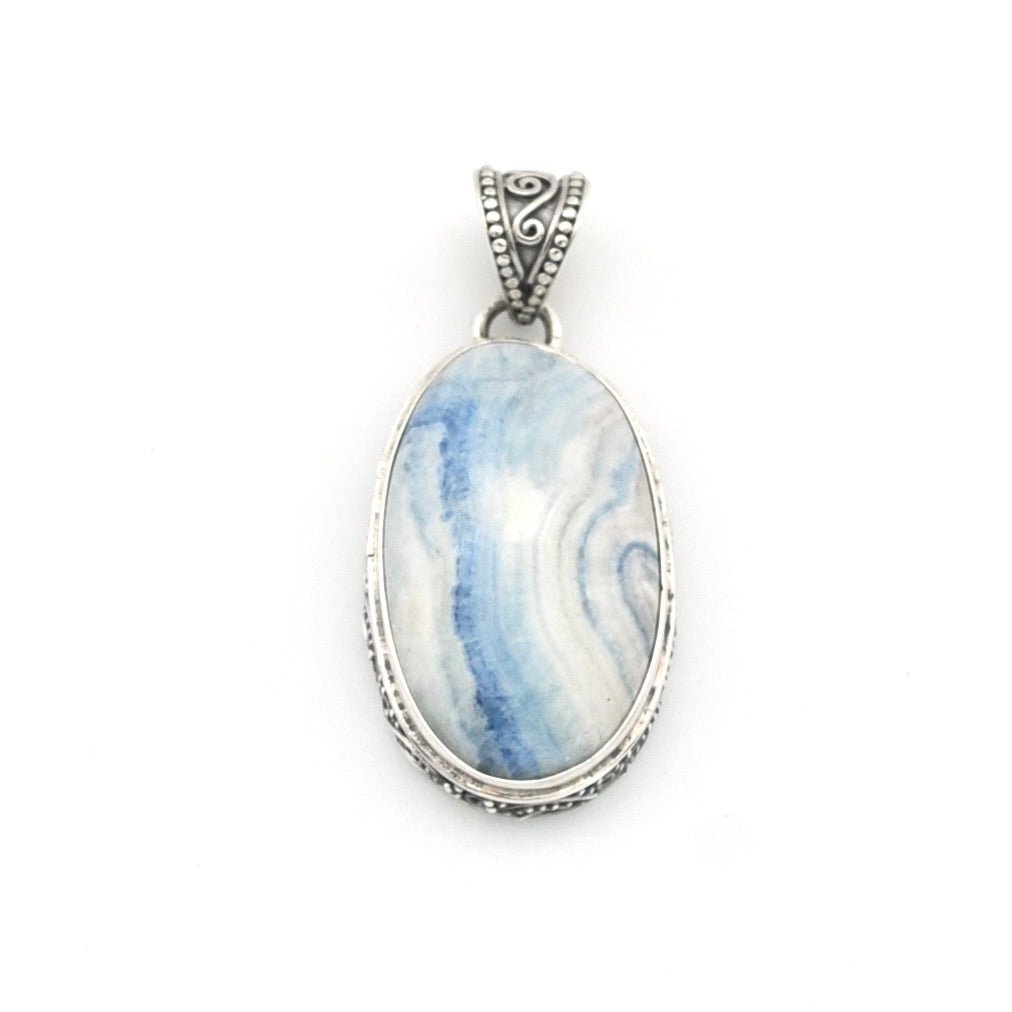 An oval pendant featuring a blue and white marbled stone, set in a textured silver bezel with an ornate silver bail, shown on a plain white background.