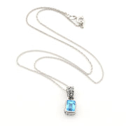 A silver-toned necklace featuring a rectangular light blue gemstone pendant in a silver bezel setting, displayed on a clean white background.