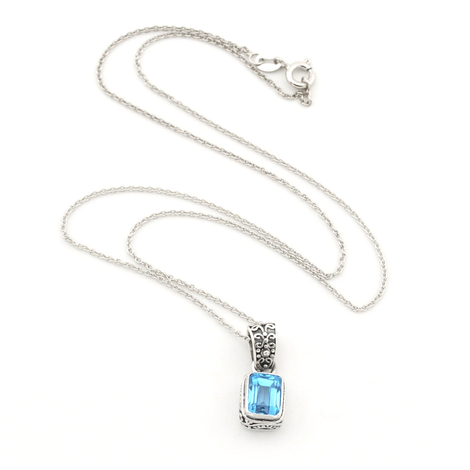 A silver-toned necklace featuring a rectangular light blue gemstone pendant in a silver bezel setting, displayed on a clean white background.