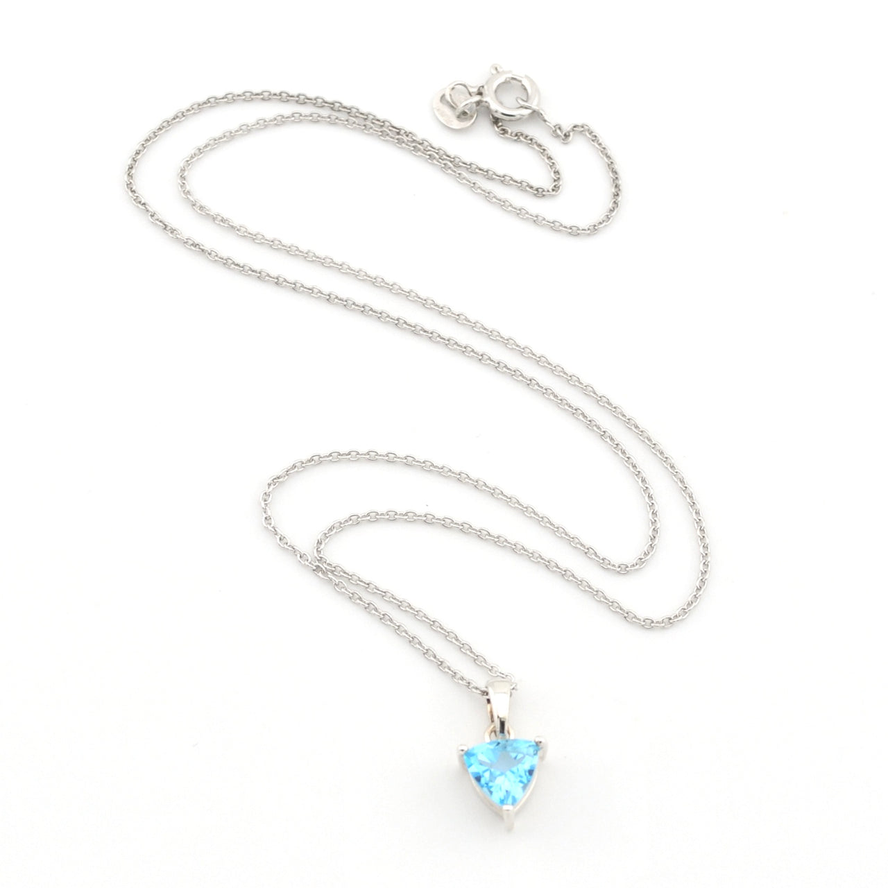 A silver chain necklace with a small trillion-shaped light blue gemstone pendant, displayed on a clean white background.
