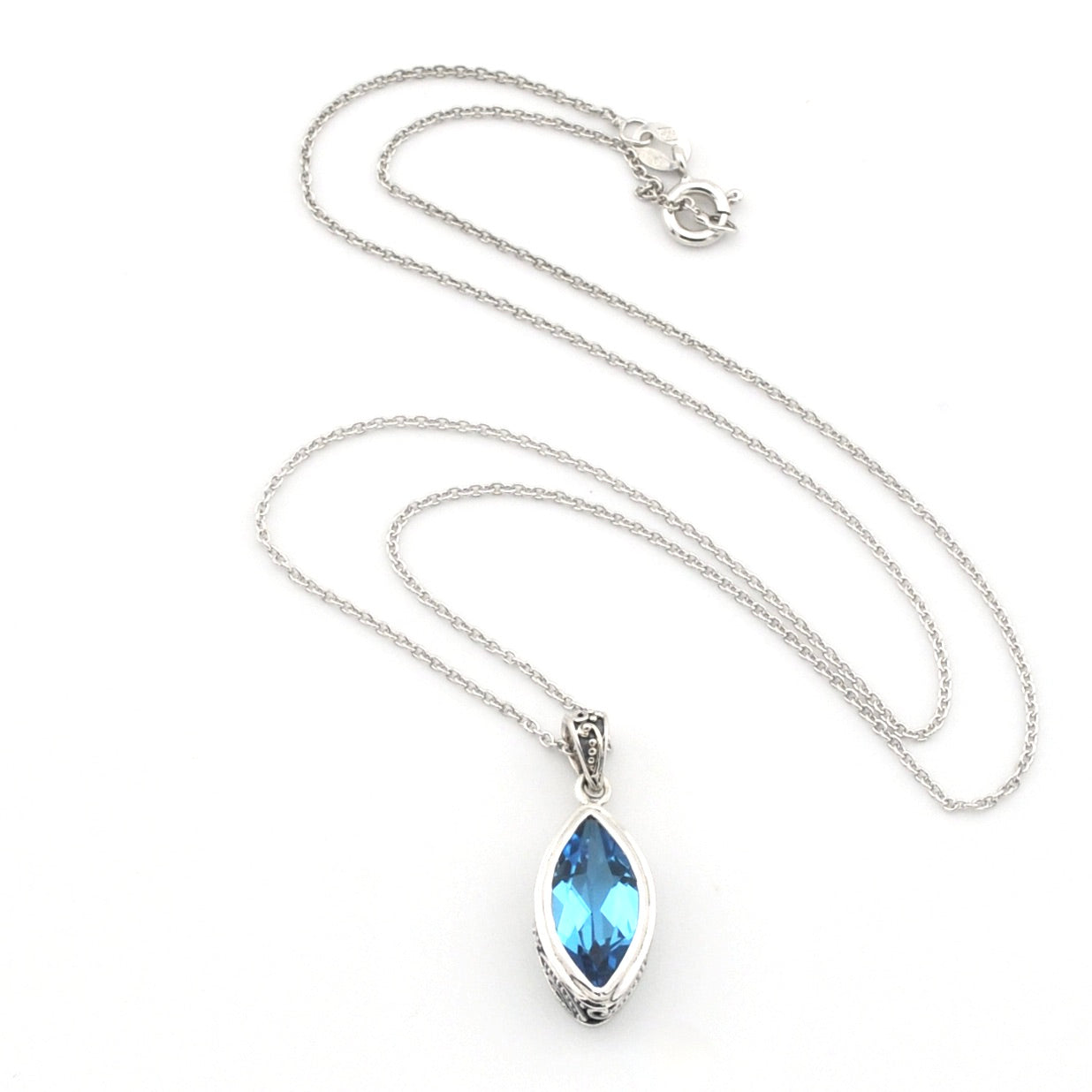 A silver-tone chain necklace with a marquise-cut light blue gemstone pendant in a silver bezel setting, displayed on a clean white background.