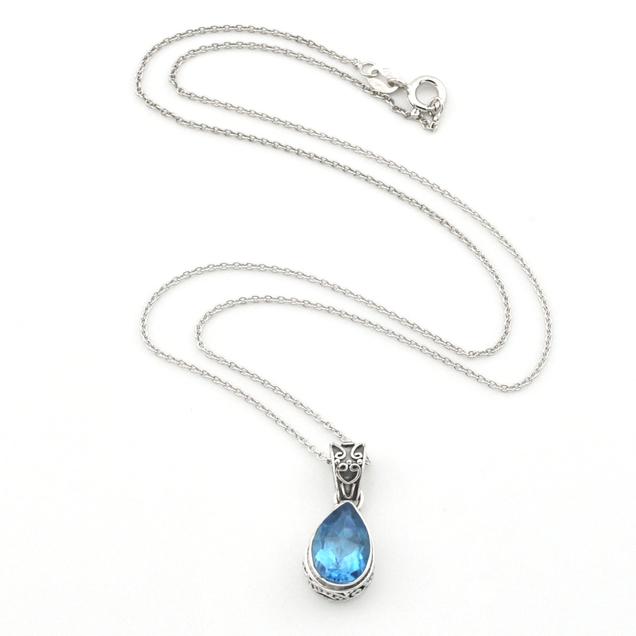 A silver chain necklace with a teardrop-shaped blue gemstone pendant in a silver setting, displayed on a clean white background.
