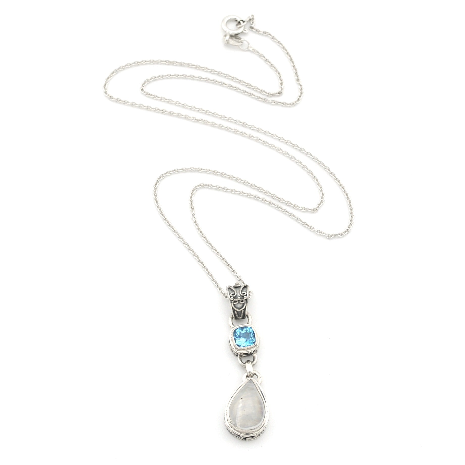 A silver pendant necklace featuring a teardrop-shaped white moonstone drop and a small rectangular light blue gemstone, displayed on a clean white background.