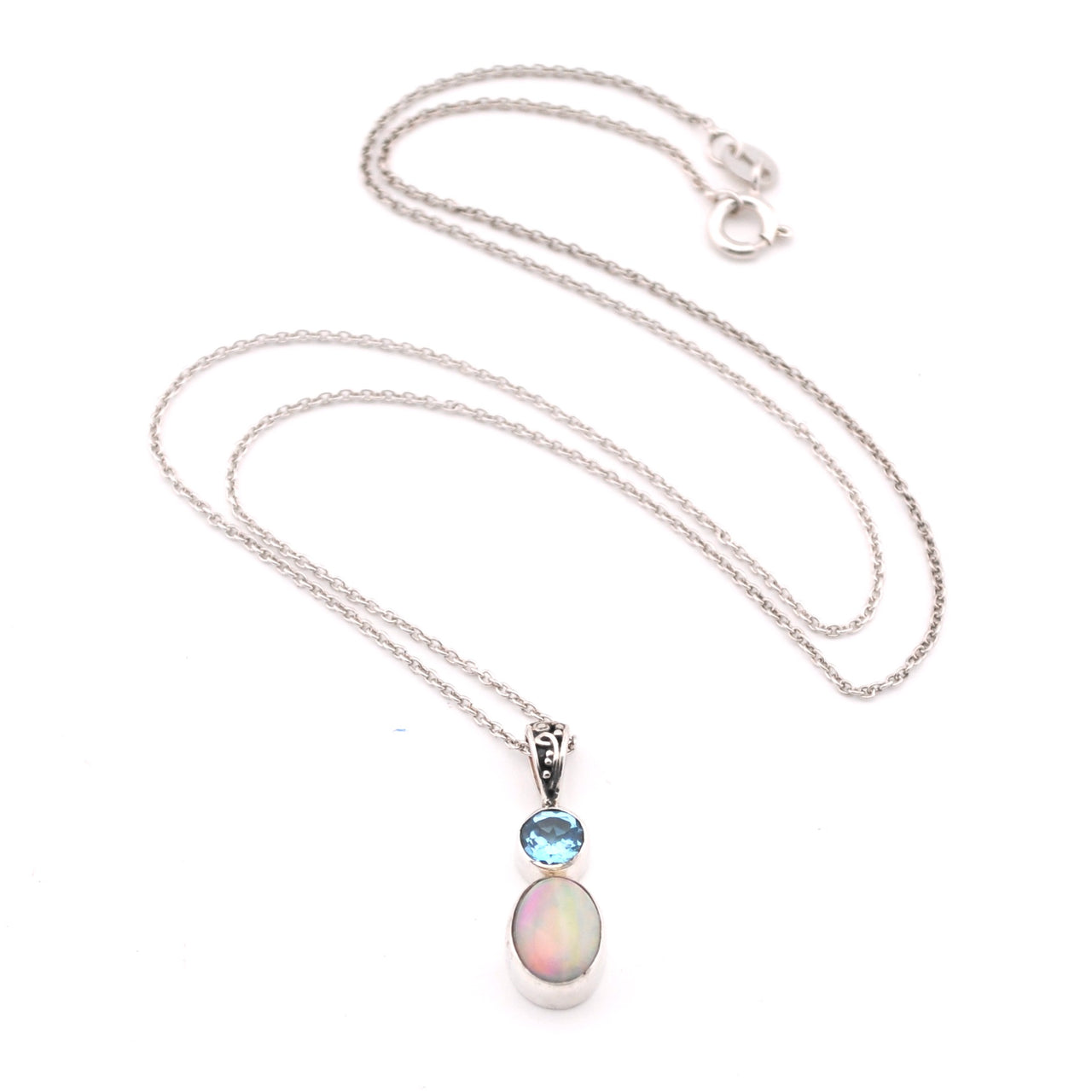 Necklace with an opal pendant and blue gemstone on a white background