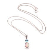 Necklace with an opal pendant and blue gemstone on a white background