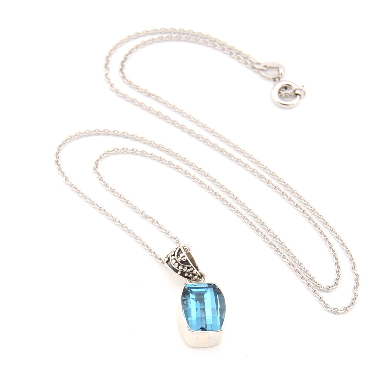 Necklace with a blue gemstone pendant on a white background