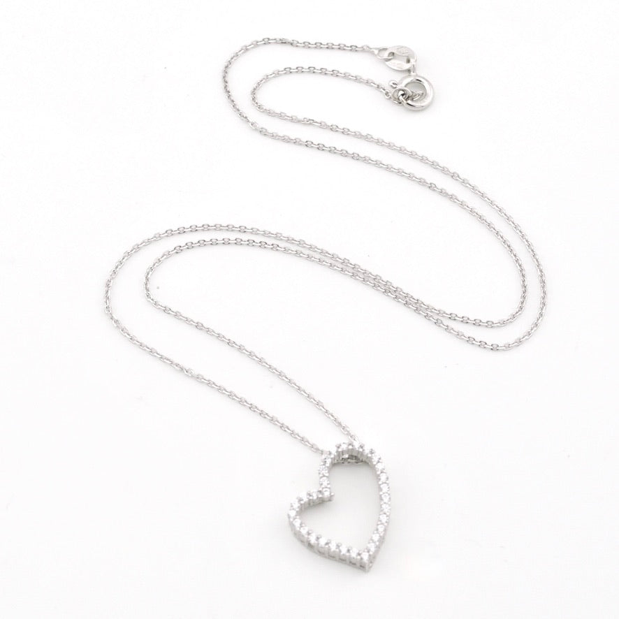 A silver heart-shaped pendant necklace with a delicate chain, displayed on a clean white background.