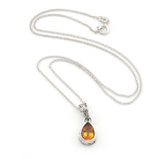 A silver teardrop pendant necklace featuring a warm citrine gemstone, displayed on a clean white background.