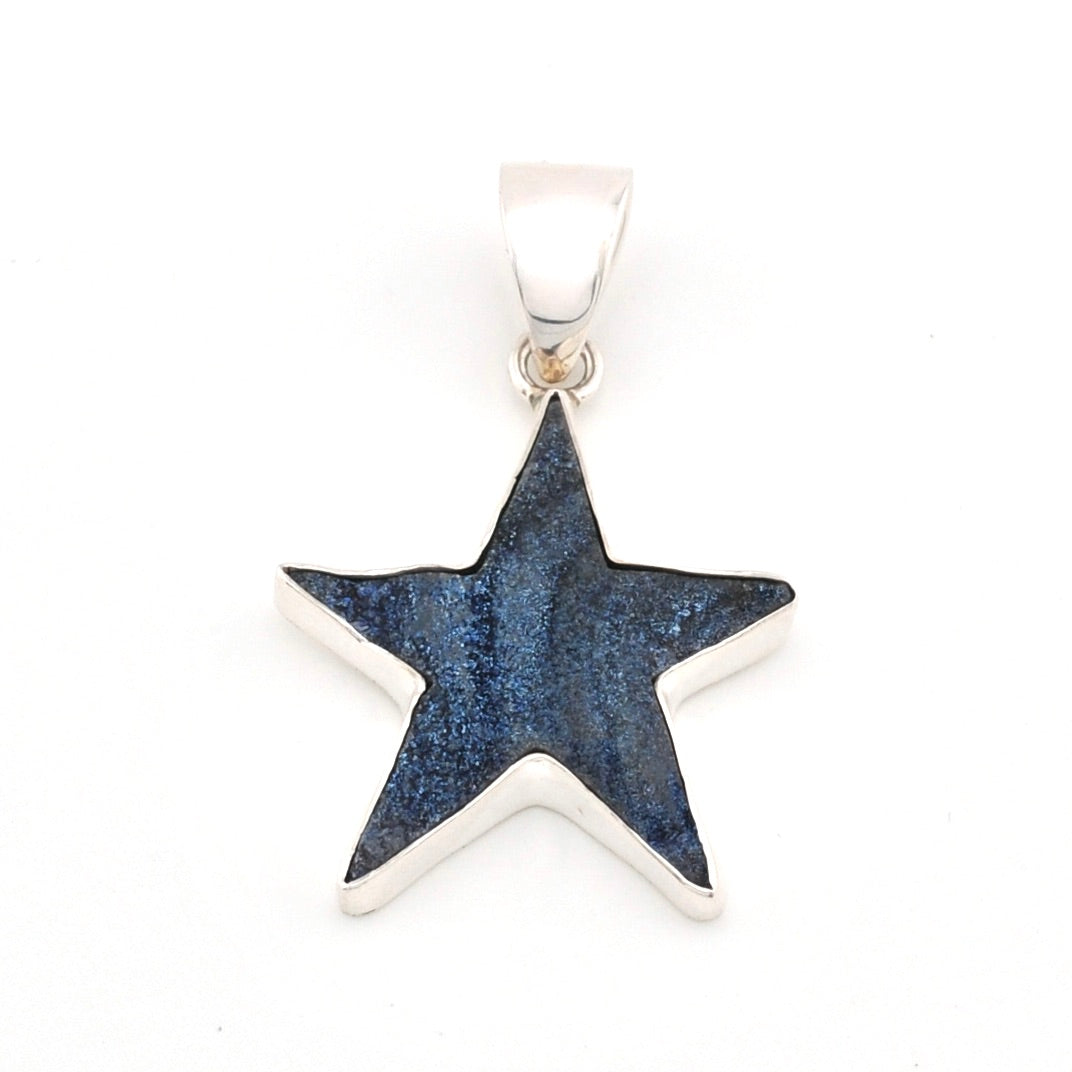 Star-shaped pendant with blue glittery center on a white background