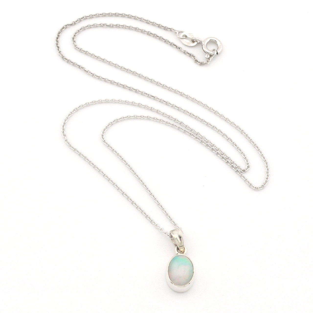 A silver chain necklace with a small oval pendant featuring a milky white stone with a soft green-blue tint, displayed on a clean white background.