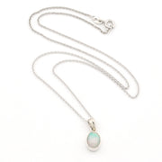 A silver chain necklace with a small oval pendant featuring a milky white stone with a soft green-blue tint, displayed on a clean white background.