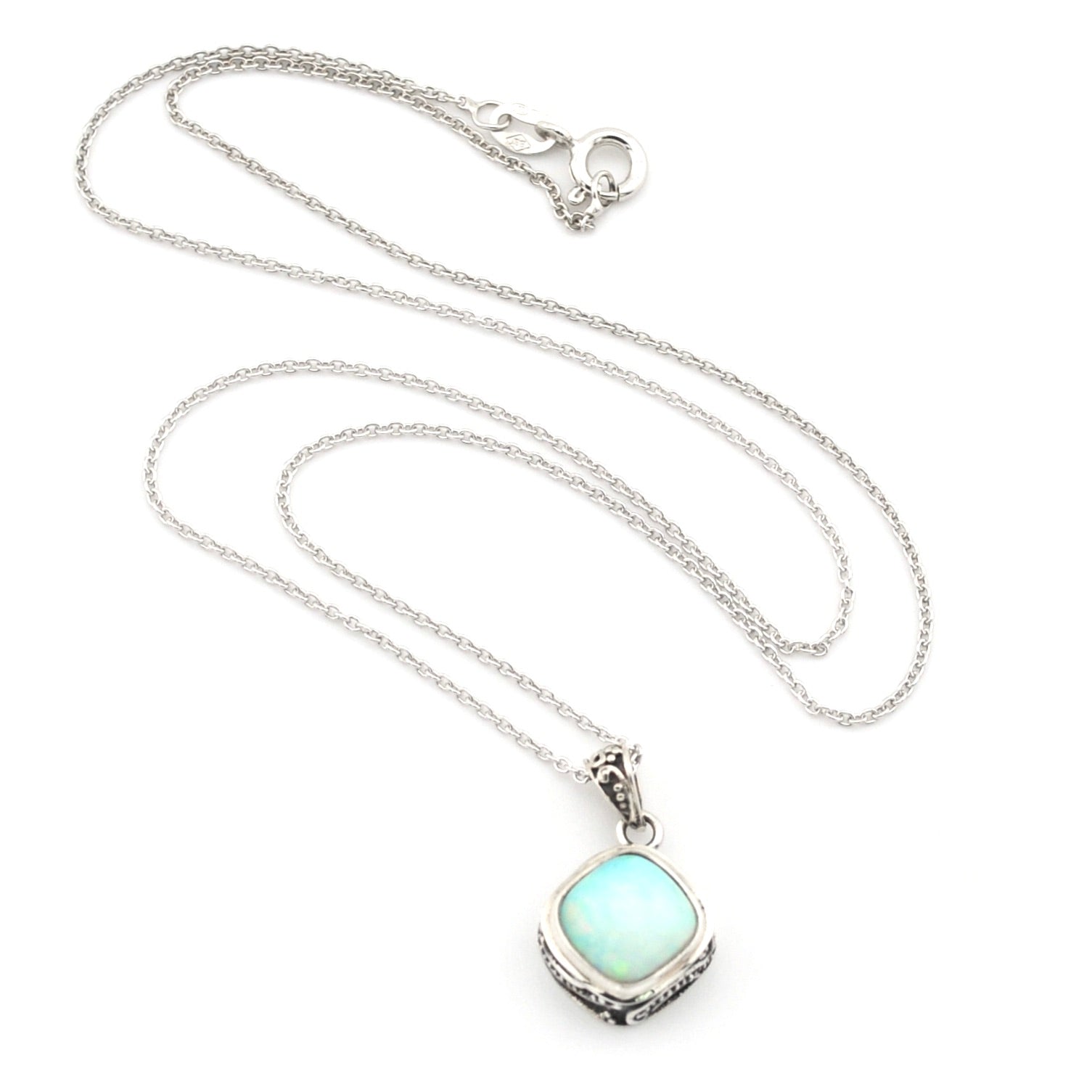 A silver chain necklace with a square pendant featuring a light blue-green opal-like stone in a silver bezel setting, displayed on a clean white background.