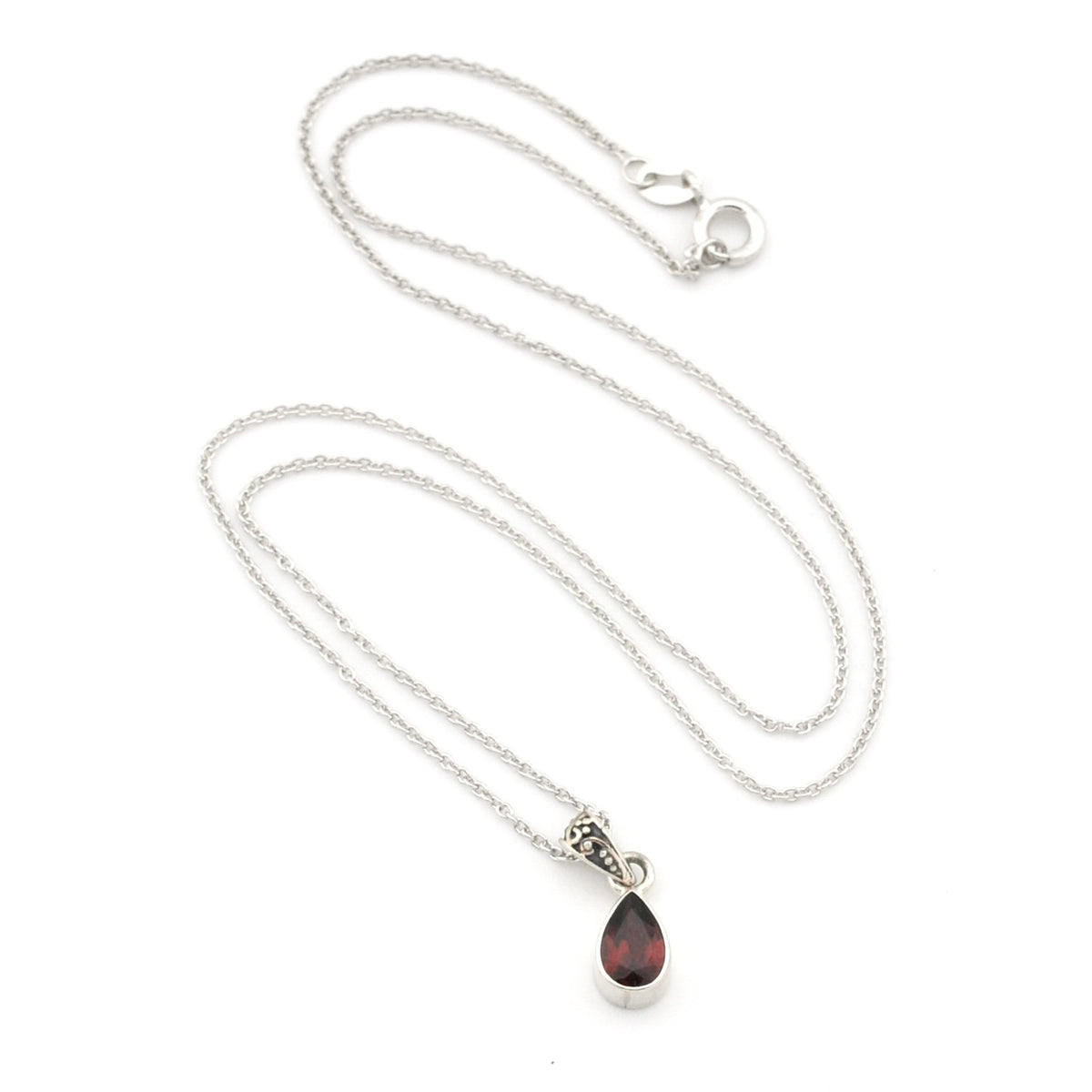 A silver chain necklace with a teardrop-shaped dark red gemstone pendant, displayed on a clean white background.