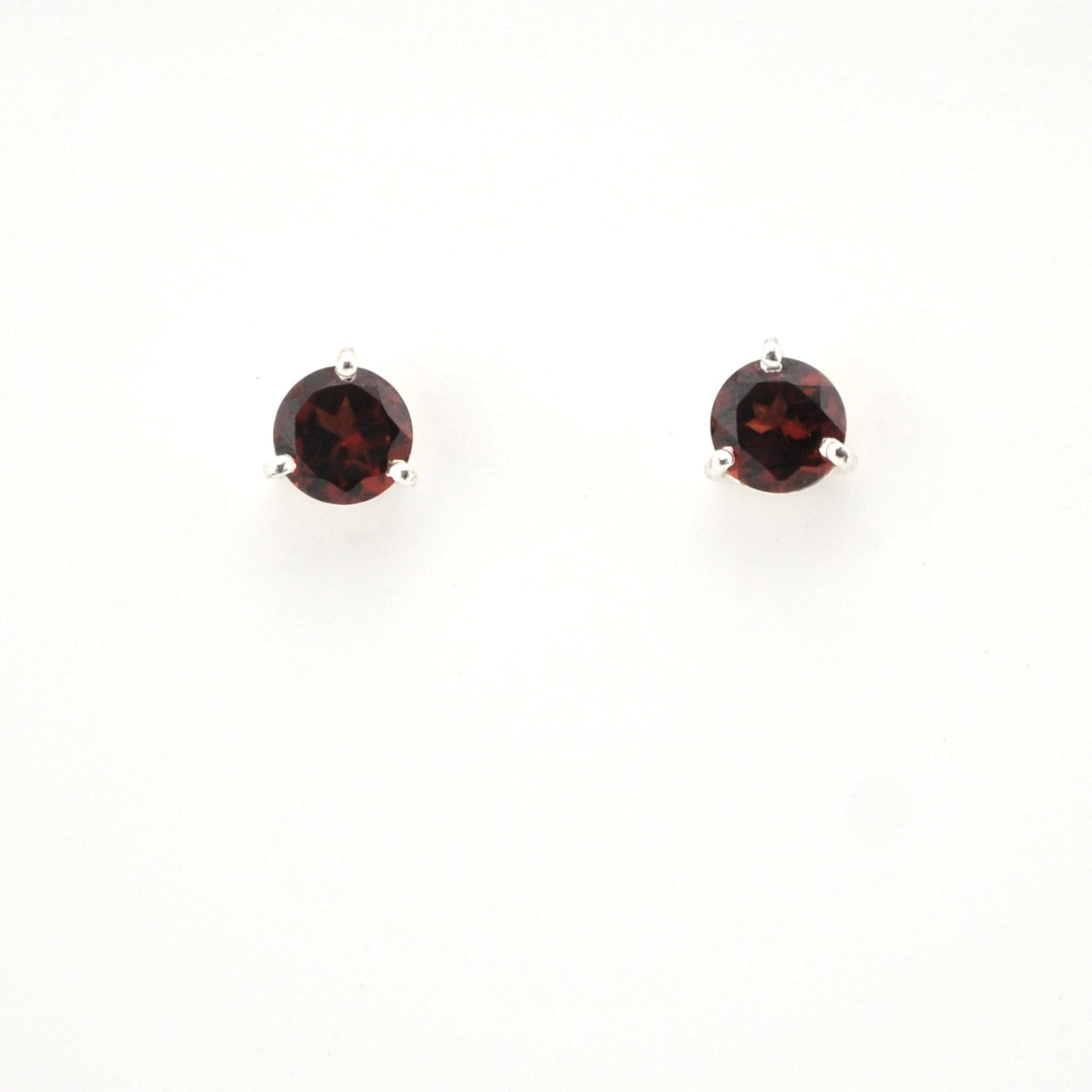 Pair of round gemstone earrings on a white background