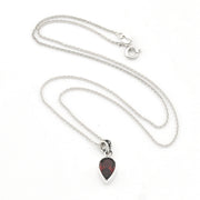 A silver chain necklace with a teardrop-shaped pendant featuring a dark red, marbled gemstone in a silver bezel setting, displayed on a clean white background.