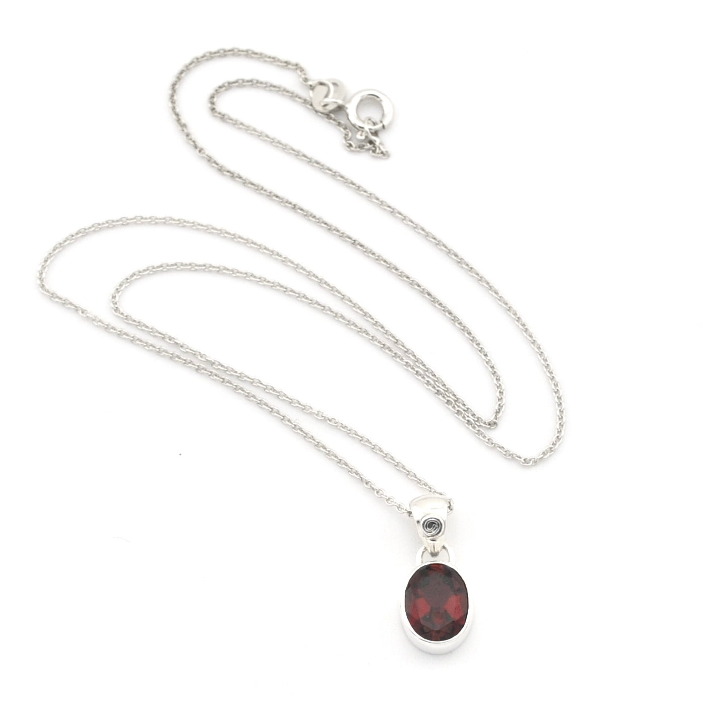 A silver chain necklace with an oval dark red gemstone pendant, displayed on a clean white background.