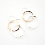 Pair of hoop earrings with gold and silver finishes on a white background