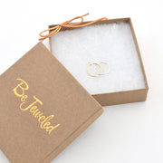 Open jewelry box with 'Be Jeweled' branding, containing a gold ring.