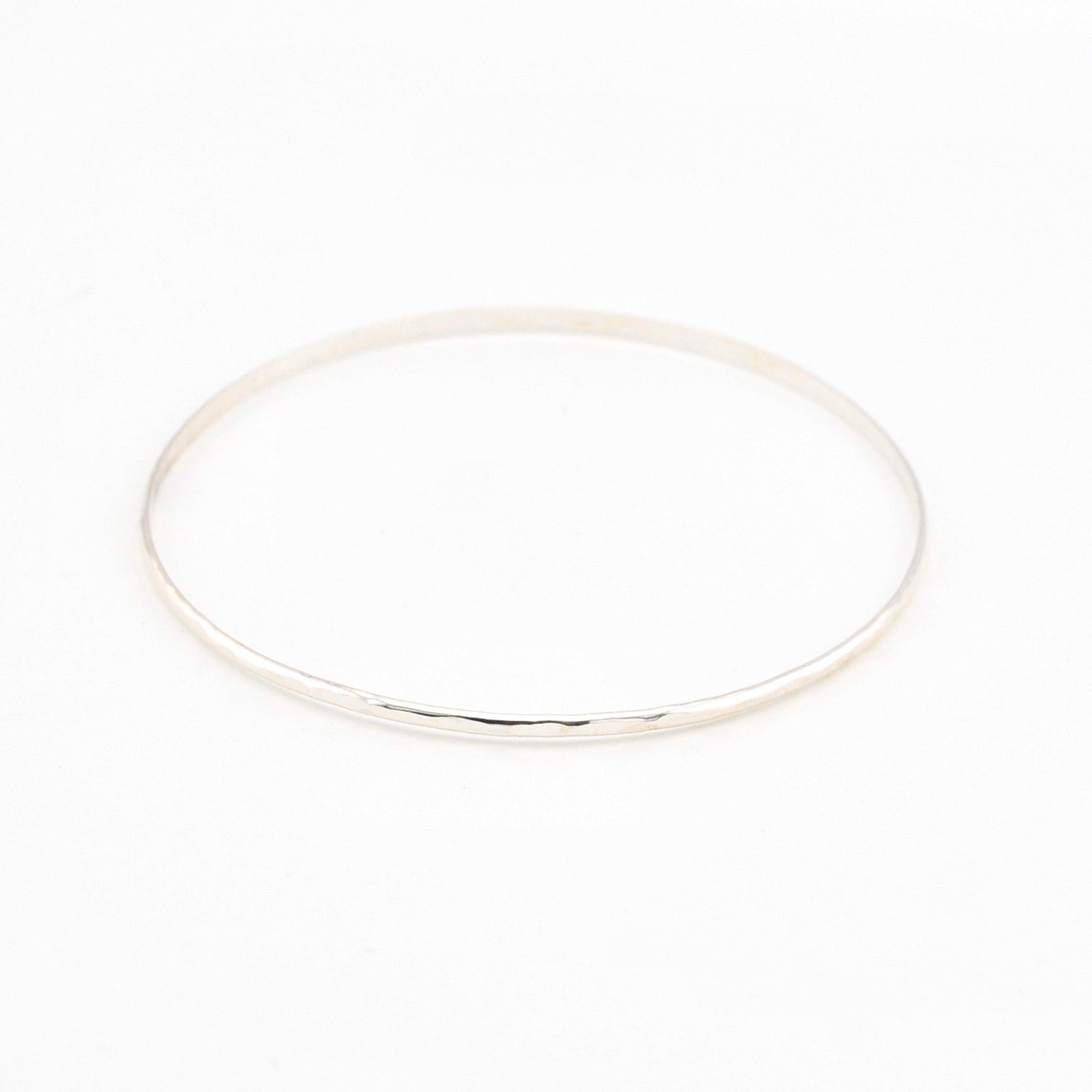 Silver bangle on a white background