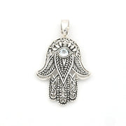 Silver Hamsa hand pendant with intricate designs on a white background
