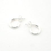 Pair of silver hoop earrings on a white background