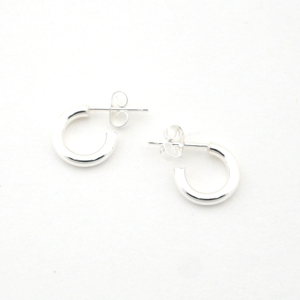 Pair of silver hoop earrings on a white background