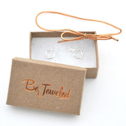 Gold hoop earrings in a 'Be Jeweled' box on a white background