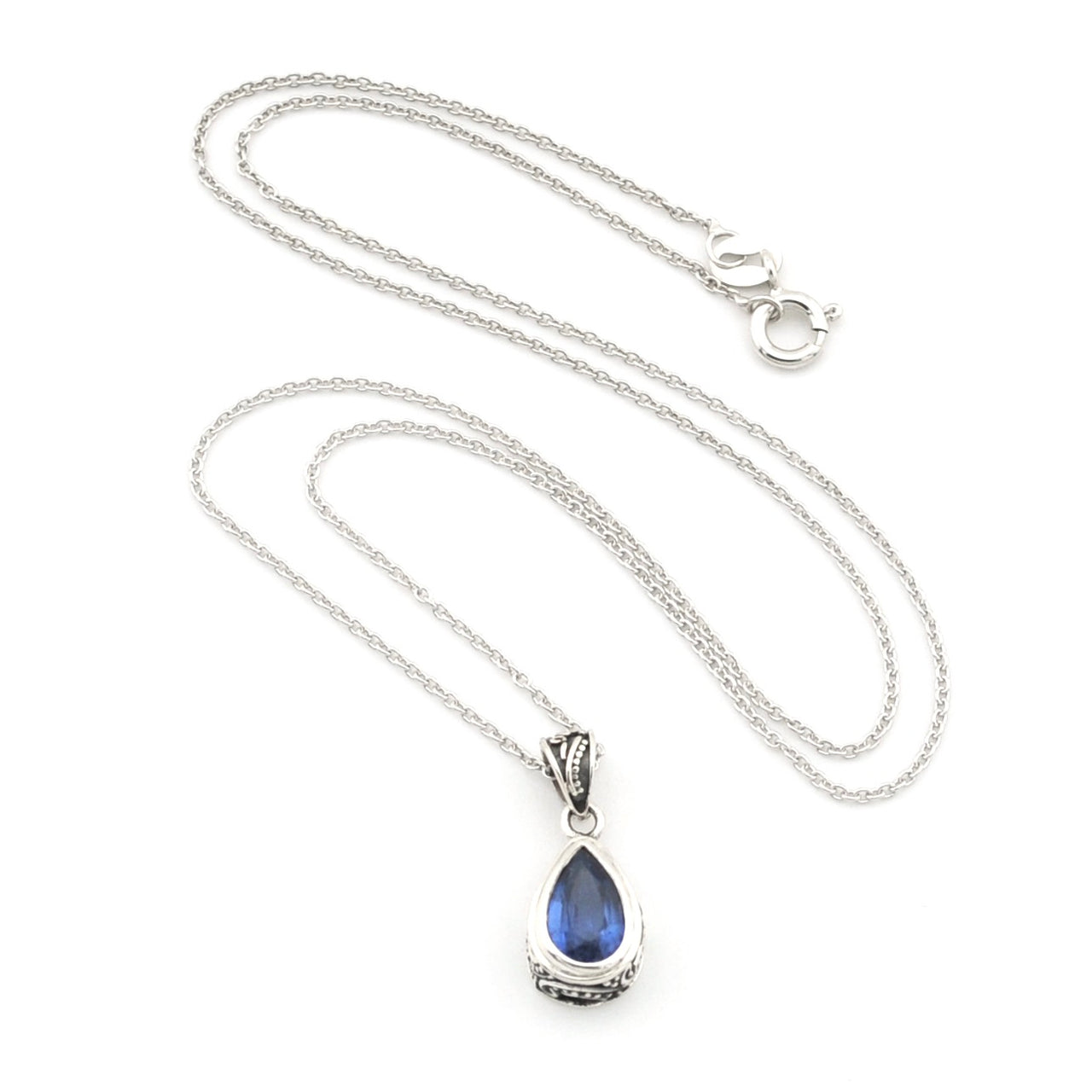 A silver teardrop pendant necklace featuring a deep blue teardrop gemstone, displayed on a clean white background.