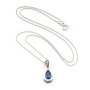 A silver teardrop pendant necklace featuring a deep blue teardrop gemstone, displayed on a clean white background.