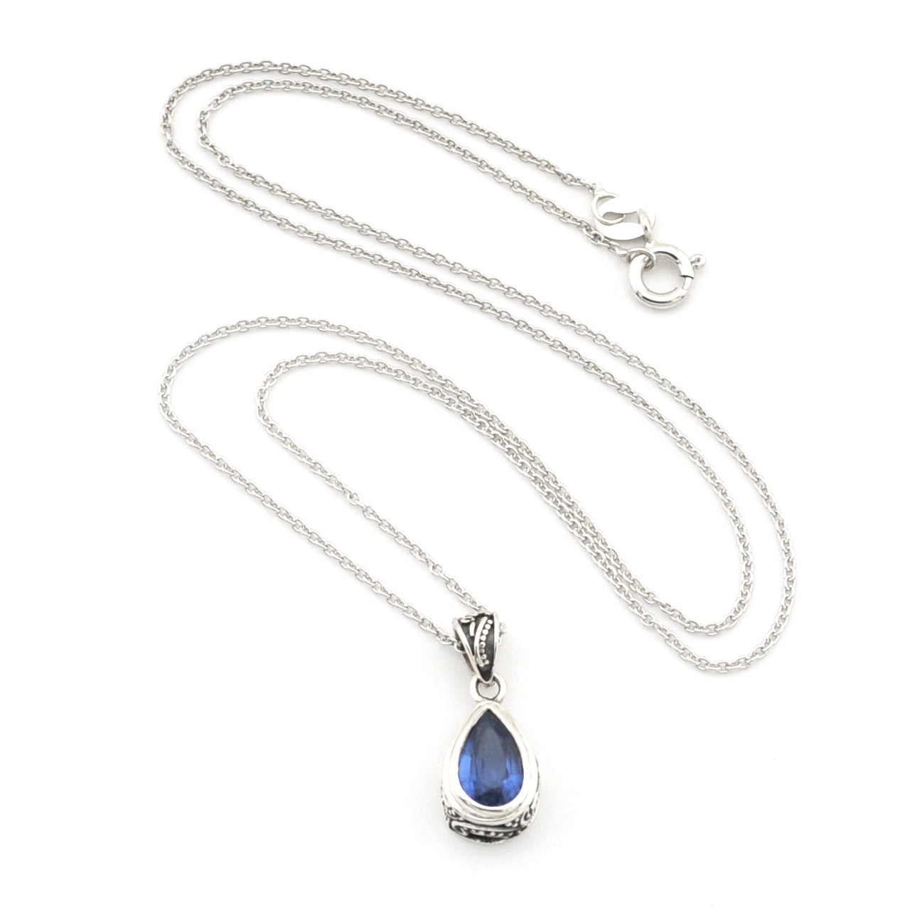 A silver teardrop pendant necklace featuring a deep blue teardrop gemstone, displayed on a clean white background.