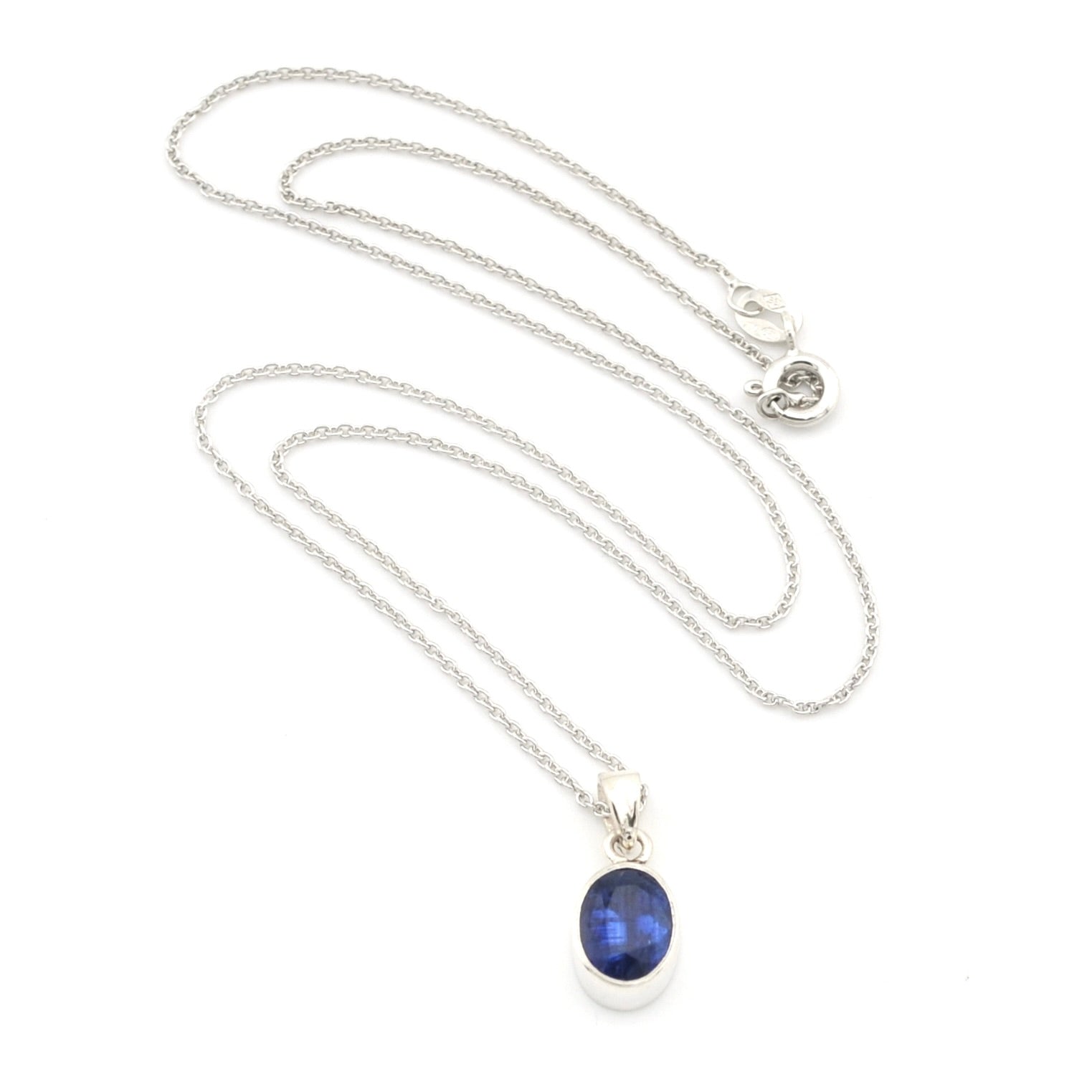 A silver chain necklace with an oval blue gemstone pendant in a silver bezel setting, displayed on a clean white background.