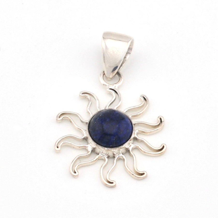 Silver sun-shaped pendant with a blue gemstone on a white background
