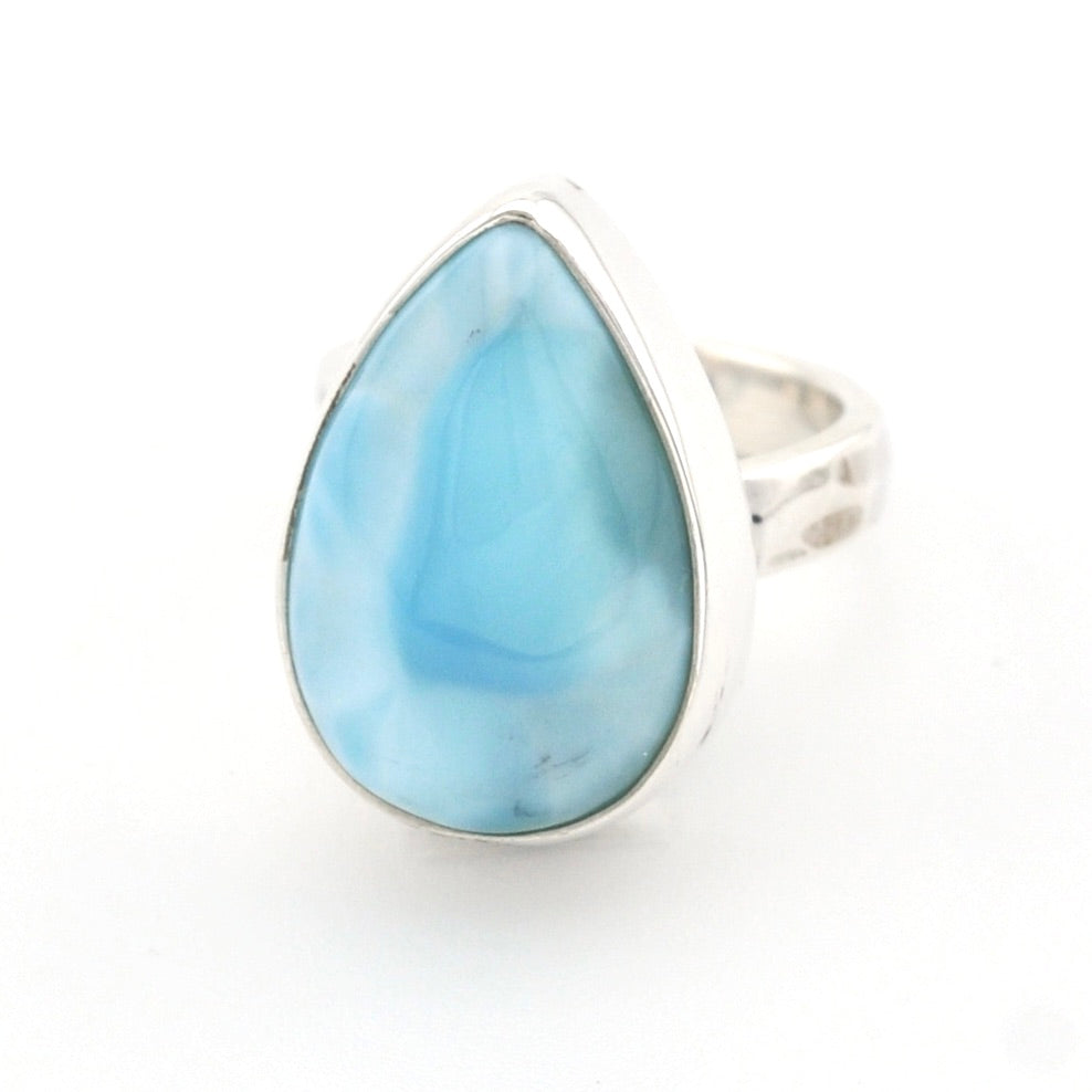 A teardrop-shaped sterling silver ring featuring a light blue marbled gemstone, set against a plain white background.