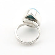 A silver-toned ring featuring a large, polished dome-shaped bezel set with a light blue stone, photographed on a clean white background.