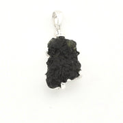 A raw moldavite pendant with a polished silver bail, shown on a plain white background.