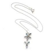 A silver flower-shaped pendant necklace featuring marquise-cut iridescent blue-gray stones, displayed on a clean white background.