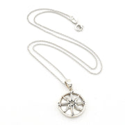 A silver compass pendant necklace on a delicate silver chain, displayed against a clean white background.