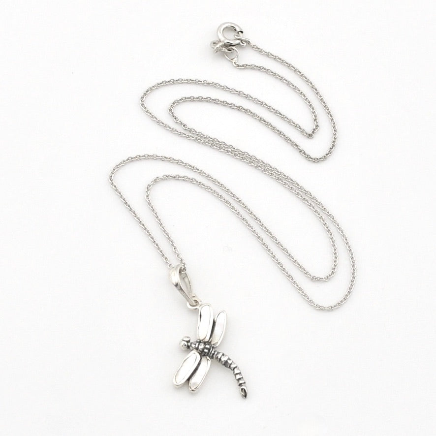 A silver dragonfly pendant necklace on a delicate silver chain, displayed on a clean white background.