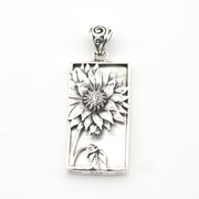 Silver pendant with sunflower design on a white background