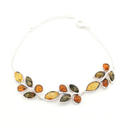 A silver leaf-shaped chain necklace featuring multiple polished amber stones in warm yellow, orange, and olive green hues, displayed on a clean white background.