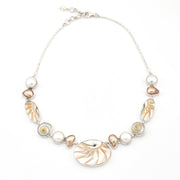 Necklace with shell and pearl beads on a white background