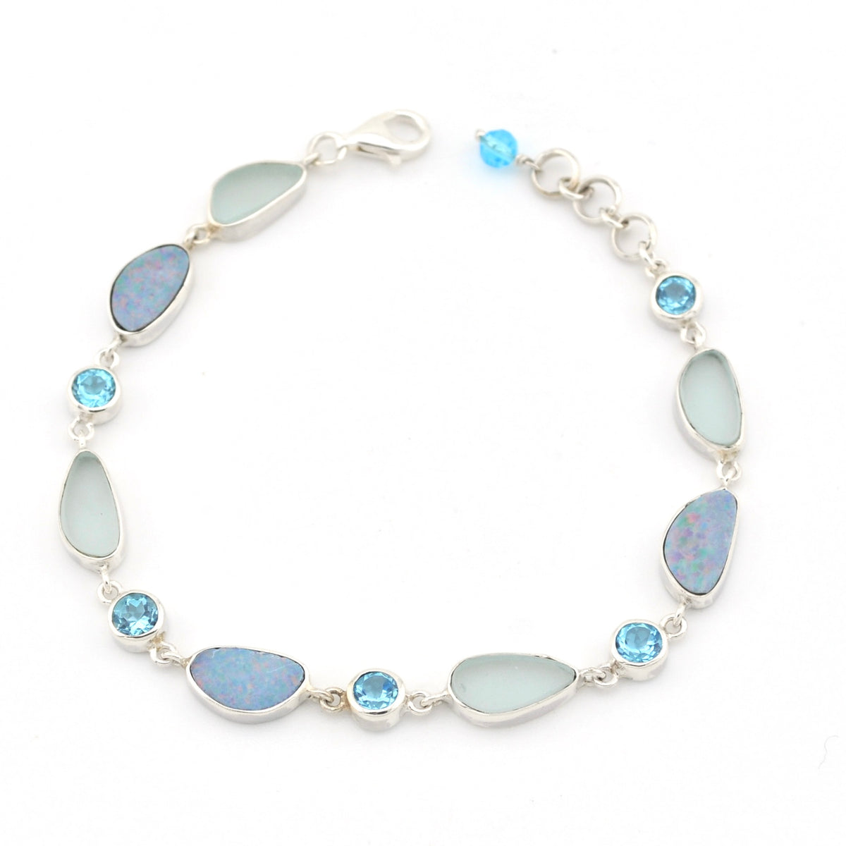 Silver bracelet with blue opal, sea glass and blue topaz on white background.
