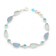 Silver bracelet with blue opal, sea glass and blue topaz on white background.
