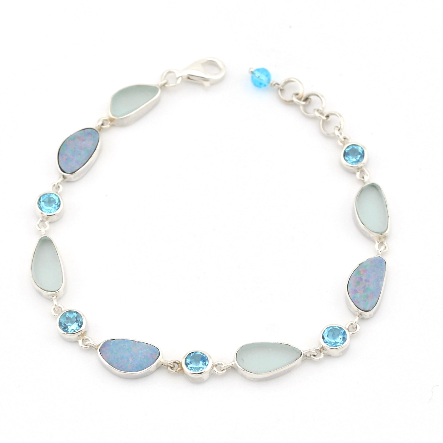 Silver bracelet with blue opal, sea glass and blue topaz on white background.