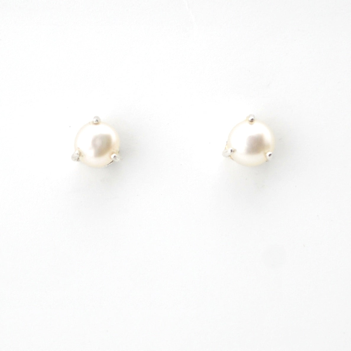 Pair of pearl earrings on a white background