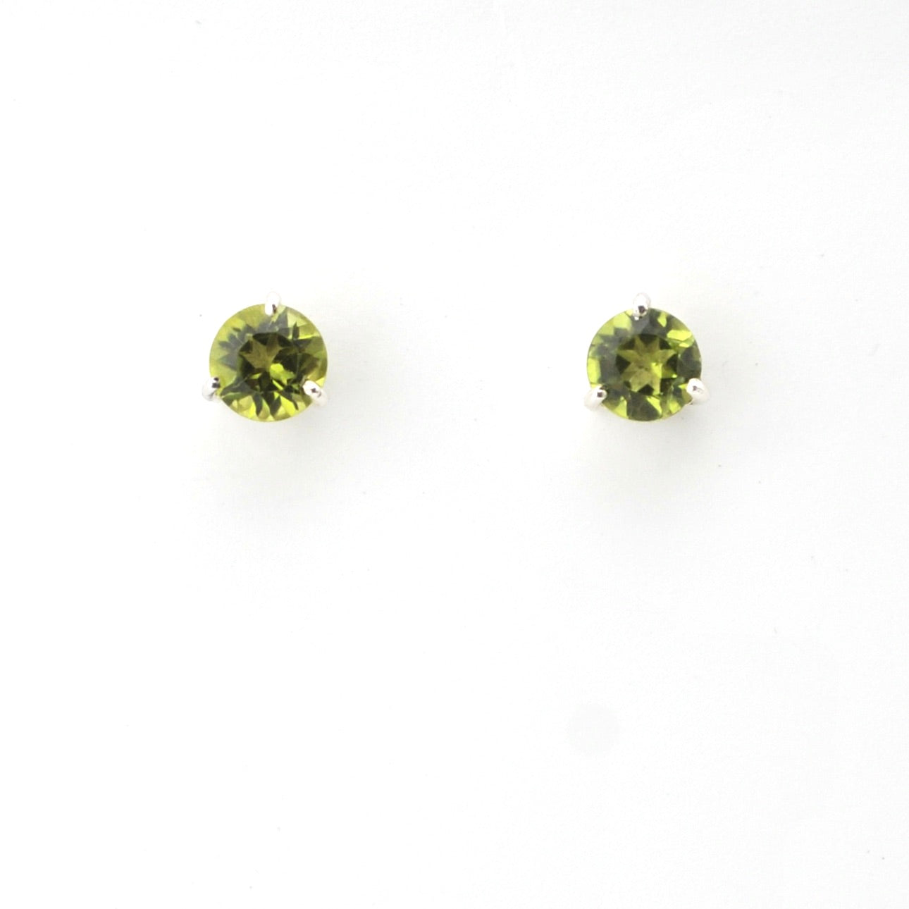 Two round green gemstones on a white background
